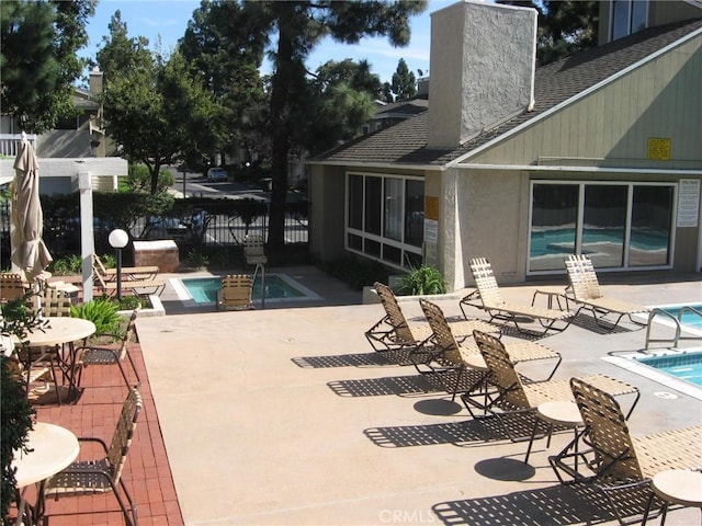 3431 Timber Lk Unit 46, Costa Mesa, CA 92626 - view of patio with fence, a community pool, and a hot tub