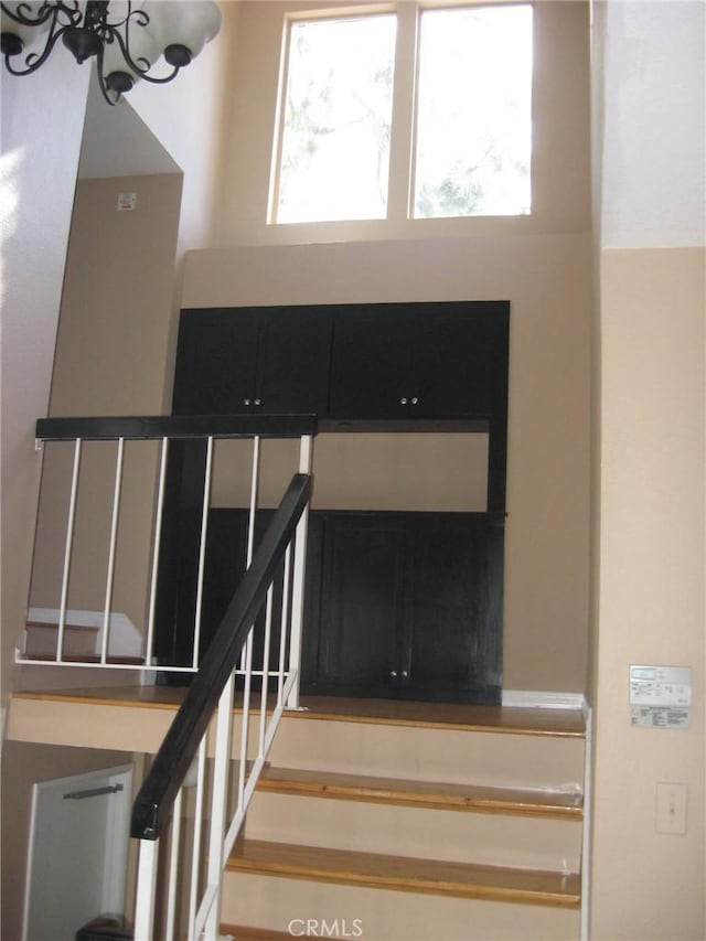 3431 Timber Lk Unit 46, Costa Mesa, CA 92626 - staircase featuring a chandelier and a wealth of natural light