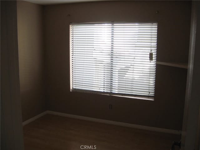 spare room with dark hardwood / wood-style floors