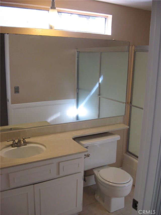 bathroom with vanity, tile patterned flooring, and toilet