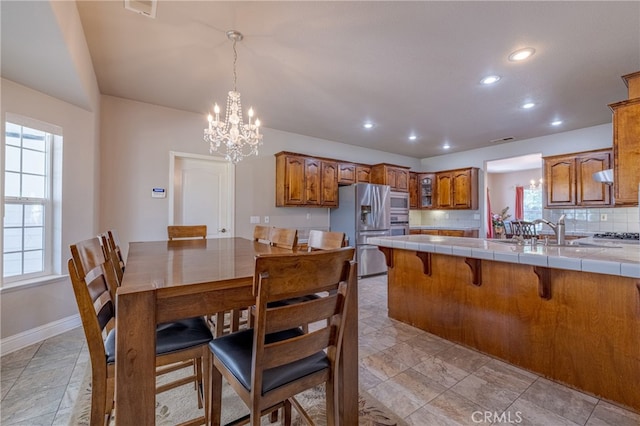 dining room featuring an inviting chandelier and sink