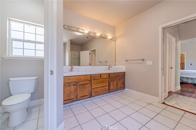 bathroom with tile patterned flooring, vanity, and toilet