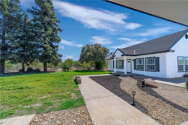 exterior space with a patio and a front lawn