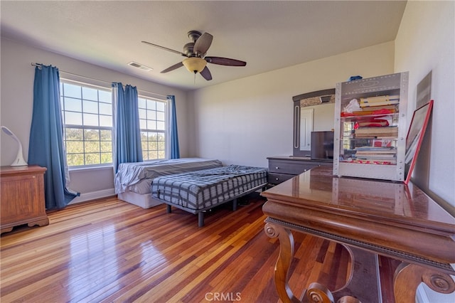 bedroom with ceiling fan and hardwood / wood-style flooring