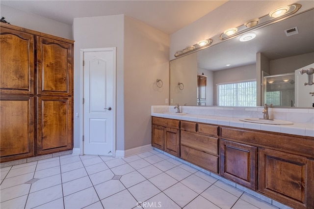 bathroom with an enclosed shower, tile patterned floors, and vanity