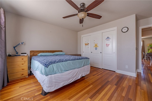 bedroom with ceiling fan, hardwood / wood-style flooring, and a closet