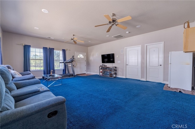 carpeted living room with ceiling fan