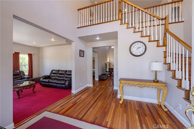 foyer featuring dark hardwood / wood-style floors and a high ceiling