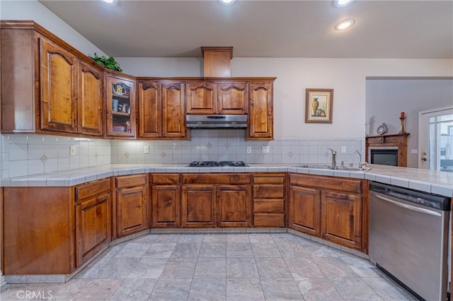 kitchen featuring tasteful backsplash, appliances with stainless steel finishes, sink, and tile counters