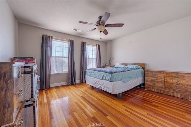 bedroom featuring ceiling fan, a textured ceiling, and wood-type flooring