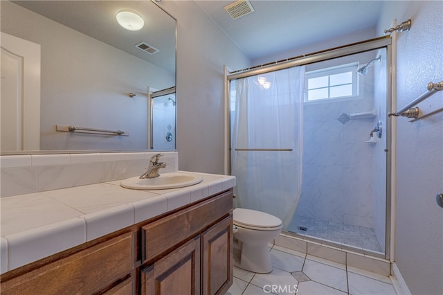 bathroom with a shower with curtain, vanity, toilet, and tile patterned floors