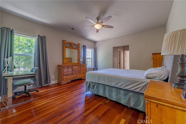 bedroom with dark hardwood / wood-style floors, multiple windows, and ceiling fan