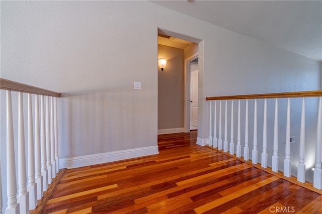 staircase with hardwood / wood-style floors