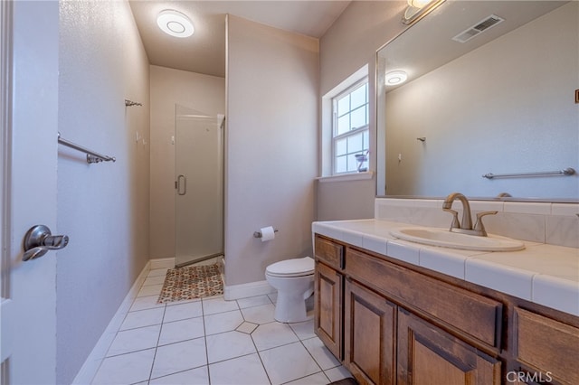 bathroom with tile patterned flooring, vanity, walk in shower, and toilet