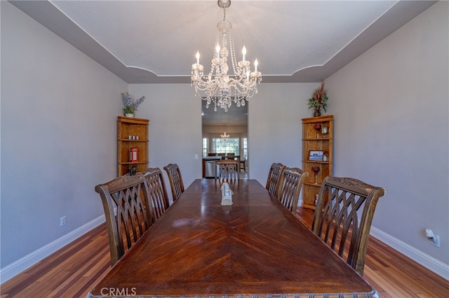 dining space with an inviting chandelier and hardwood / wood-style floors