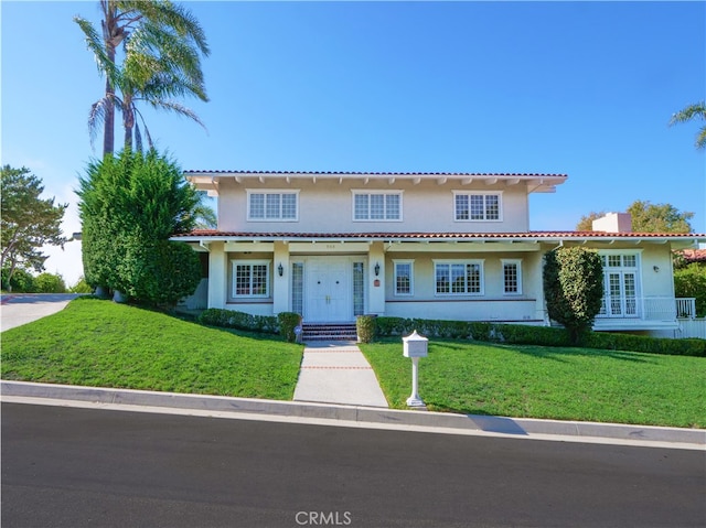 mediterranean / spanish-style house featuring a front lawn