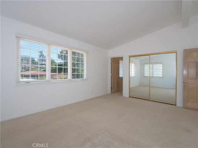 unfurnished bedroom featuring light colored carpet, a closet, and multiple windows