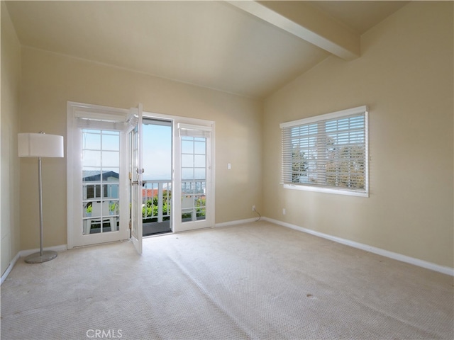 unfurnished room featuring vaulted ceiling with beams and light carpet