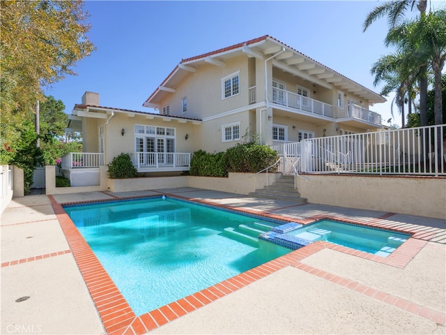 view of swimming pool featuring an in ground hot tub and a patio area