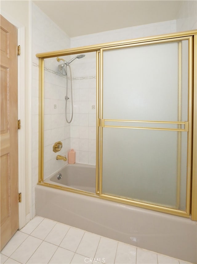 bathroom with tile patterned flooring and shower / bath combination with glass door