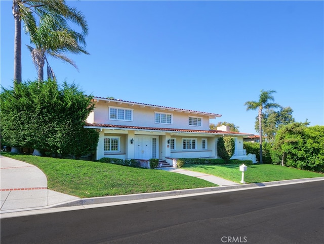 mediterranean / spanish-style house featuring a front yard