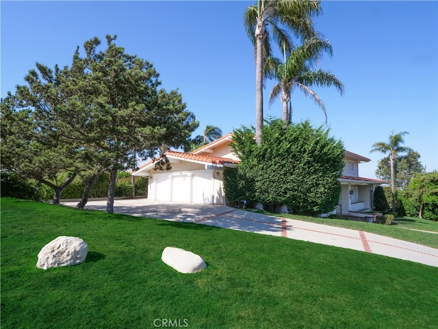 view of front of property with a garage and a front yard