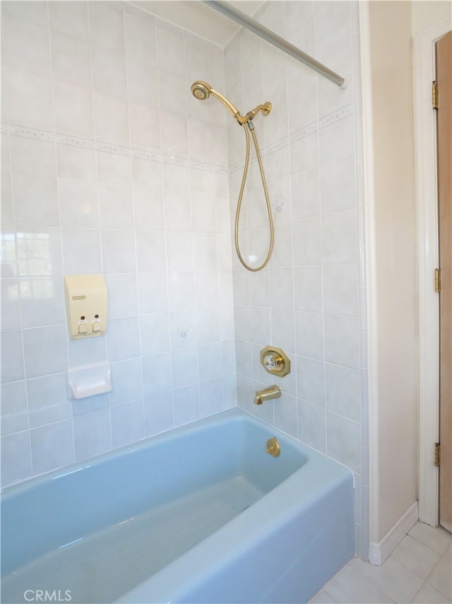 bathroom featuring tiled shower / bath and tile patterned flooring