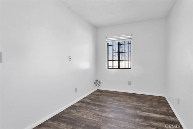 empty room with dark wood-type flooring