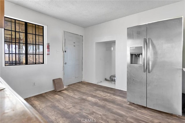 interior space with hardwood / wood-style flooring and a textured ceiling