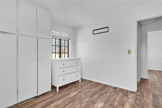 unfurnished bedroom featuring dark wood-type flooring