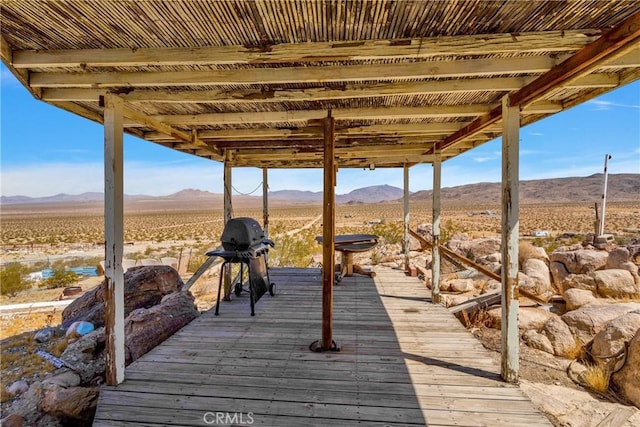 exterior space with a mountain view and grilling area