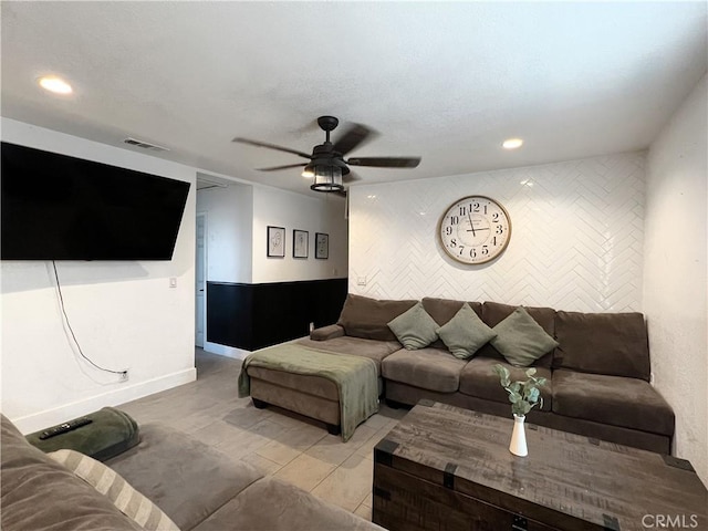 living room featuring ceiling fan and light tile patterned floors