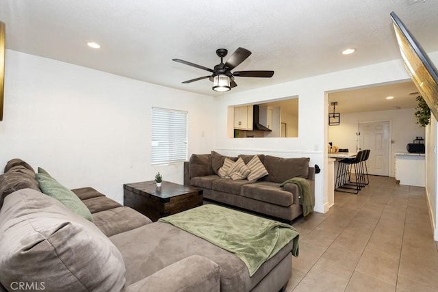 tiled living room with ceiling fan