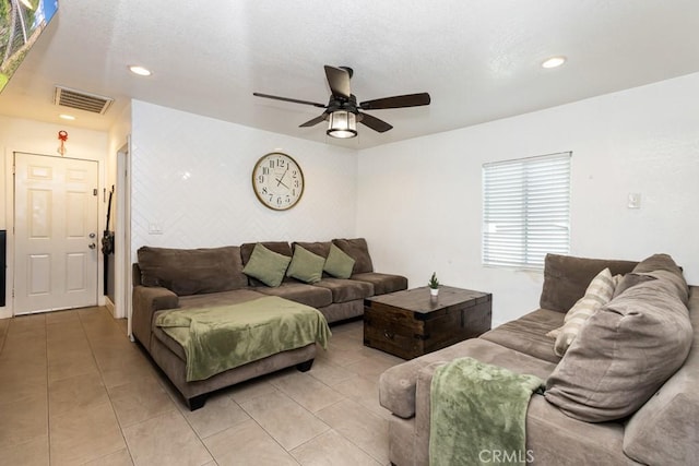 living room with ceiling fan and light tile patterned flooring