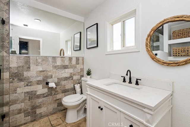 bathroom with vanity, toilet, and a shower with shower door