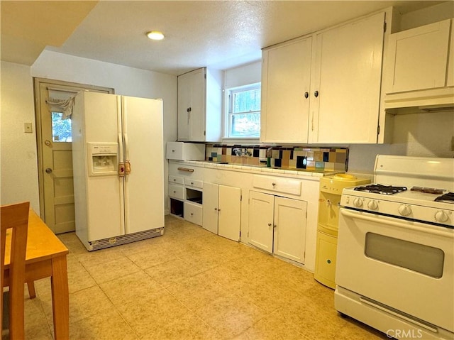 kitchen with white cabinetry and white appliances