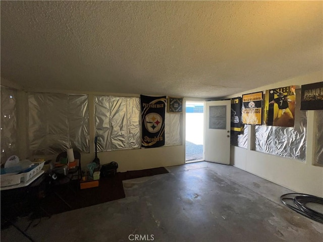 basement featuring a textured ceiling