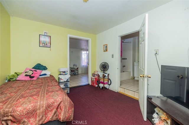 bedroom featuring connected bathroom and carpet