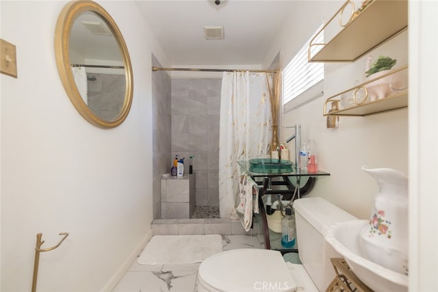 bathroom featuring toilet and a shower with shower curtain