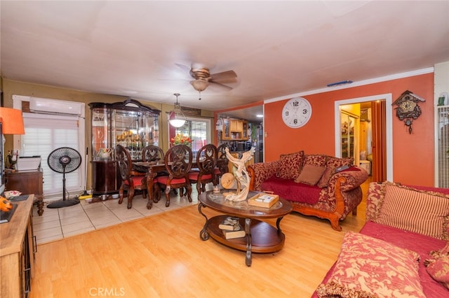 living room with hardwood / wood-style flooring, an AC wall unit, and ceiling fan