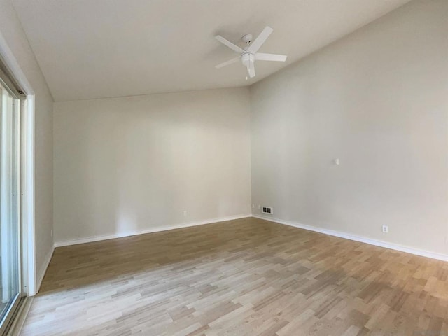 unfurnished room featuring ceiling fan, light hardwood / wood-style flooring, and vaulted ceiling