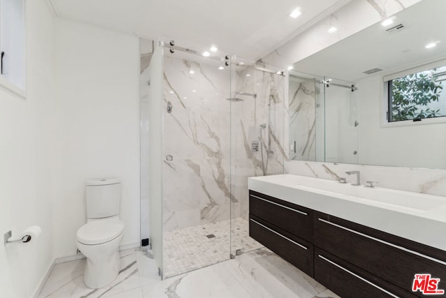 bathroom featuring toilet, a shower with shower door, and vanity