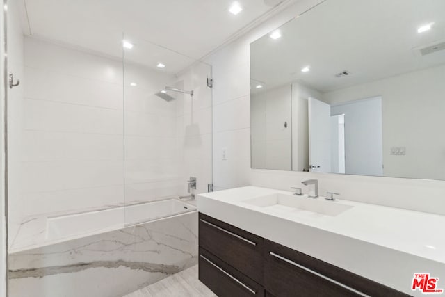 bathroom with vanity and tiled shower / bath combo