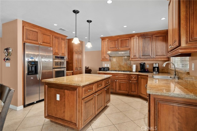 kitchen with a center island, sink, hanging light fixtures, stainless steel appliances, and light tile patterned flooring