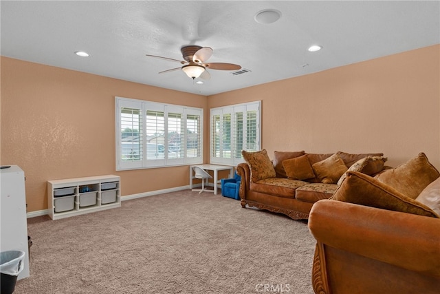 living room featuring carpet flooring and ceiling fan