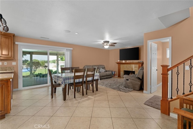 dining area with ceiling fan and light tile patterned floors