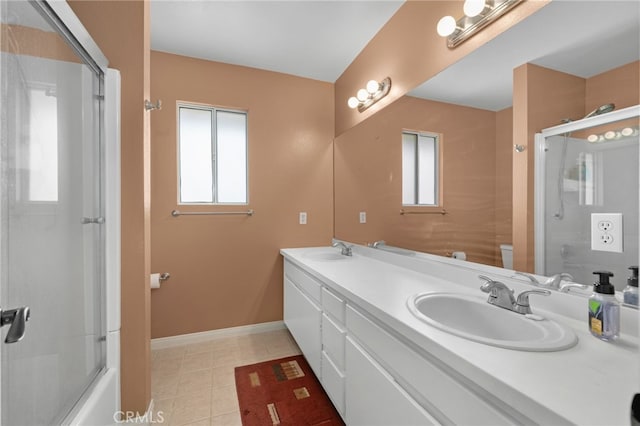 bathroom featuring tile patterned flooring, vanity, combined bath / shower with glass door, and plenty of natural light