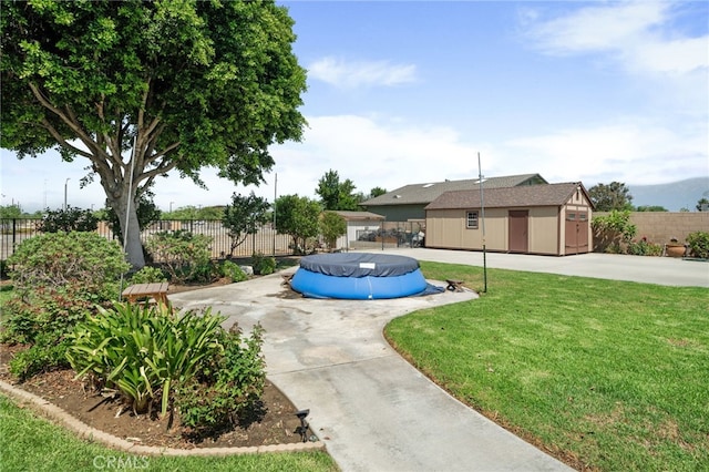 view of pool featuring an outdoor structure and a lawn