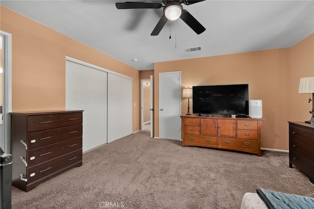 carpeted bedroom featuring a closet and ceiling fan