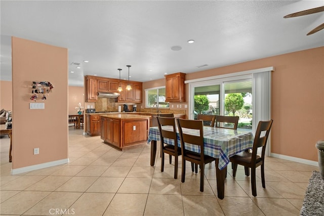 dining space featuring light tile patterned floors and ceiling fan